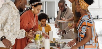 A joyful family gathering around the kitchen table for a meal, fostering togetherness and celebration.