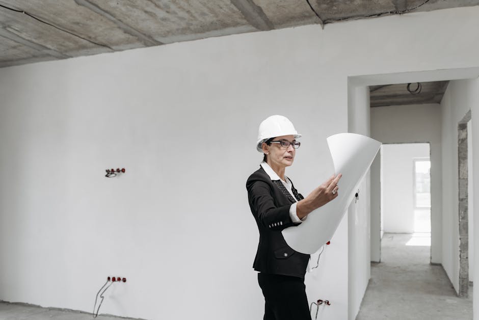 Professional female architect examining construction plans in a modern building