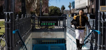 Man in historical uniform exiting subway in Buenos Aires, Argentina, on a sunny day.