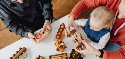 Family engaging in educational play with wooden puzzles. Perfect for learning and bonding.